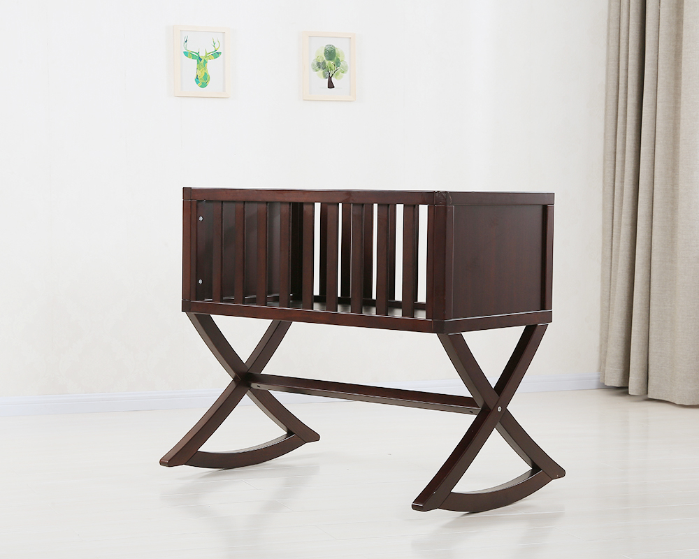 Space-saving wooden bassinet in a small nursery